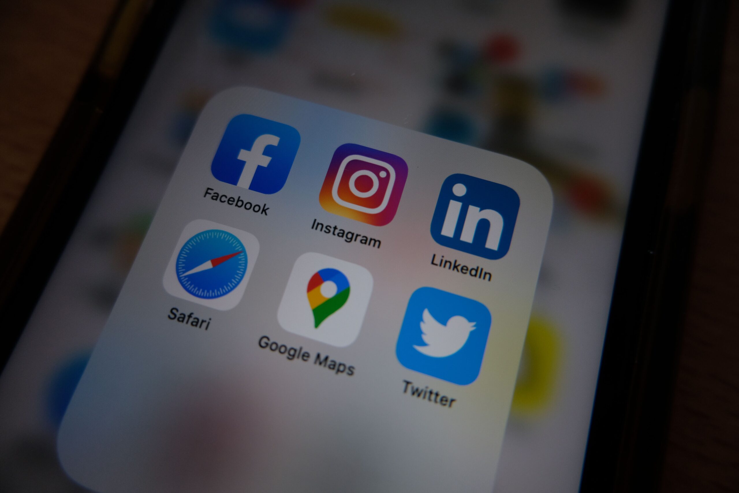 Close up of a smartphone home screen showing Facebook, Instagram, LinkedIn, Safari, Google Maps and Twitter app icons